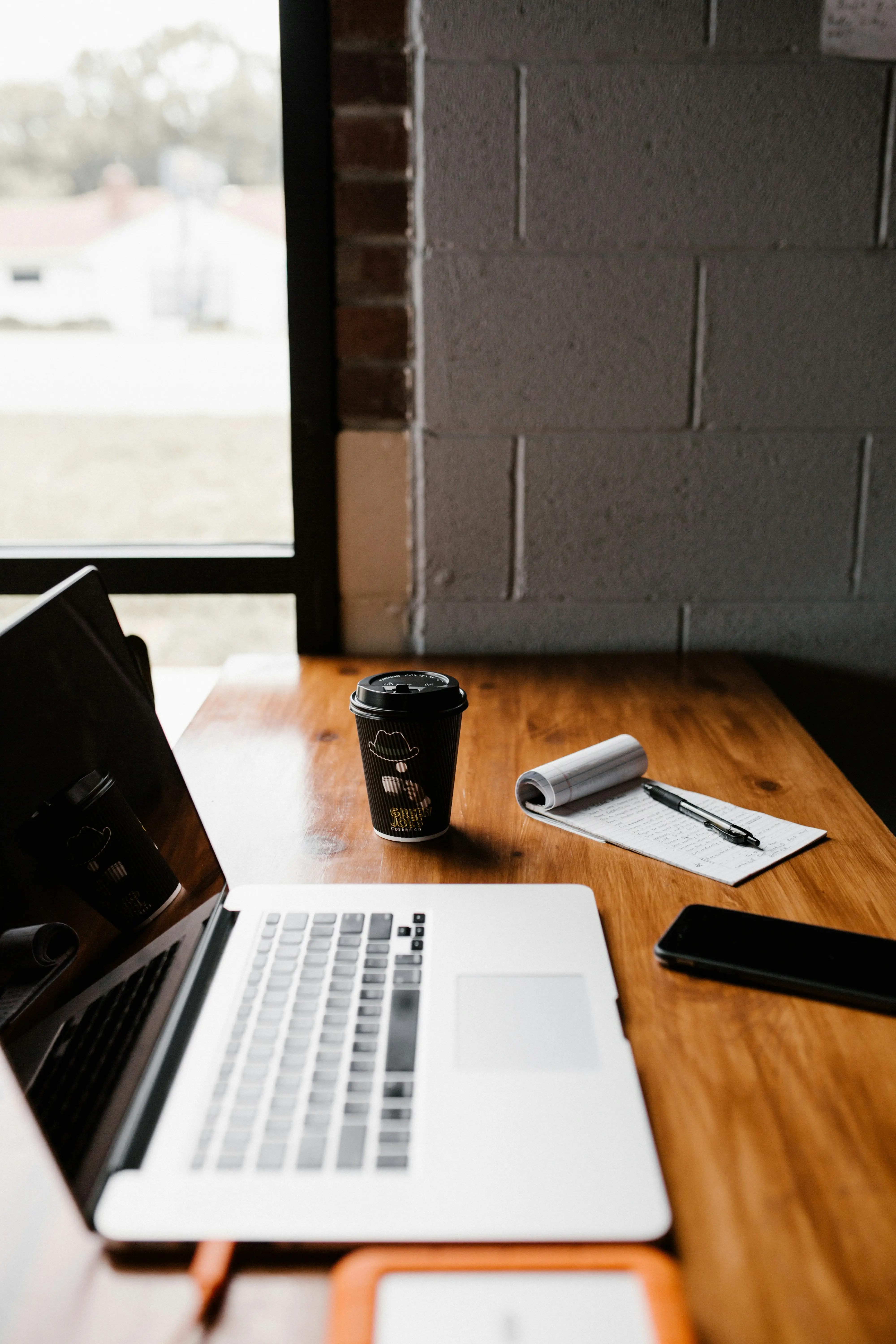An empty desk with a closed laptop and a coffee cup, the lead callback that never happened
