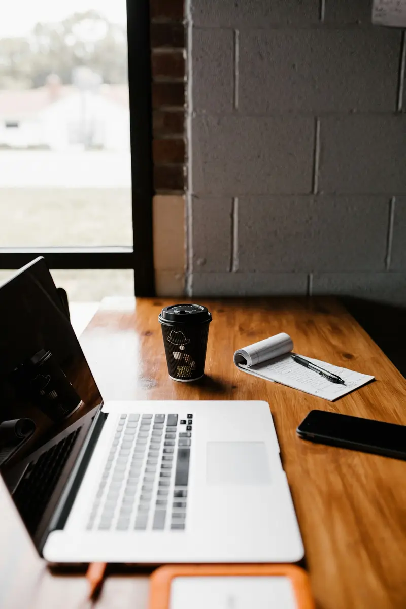 An empty desk with a closed laptop and a coffee cup, the lead callback that never happened